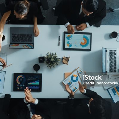 Top view of executive manager present growth graph while smart team clap hands and shale hand with marketing group to celebrate successful project. Represented love, teamwork and unity Directorate.